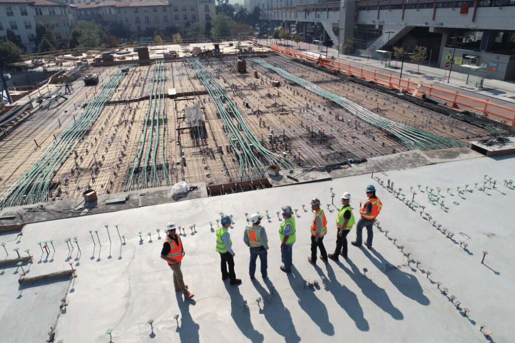 Construction workers overseeing a large-scale construction site.