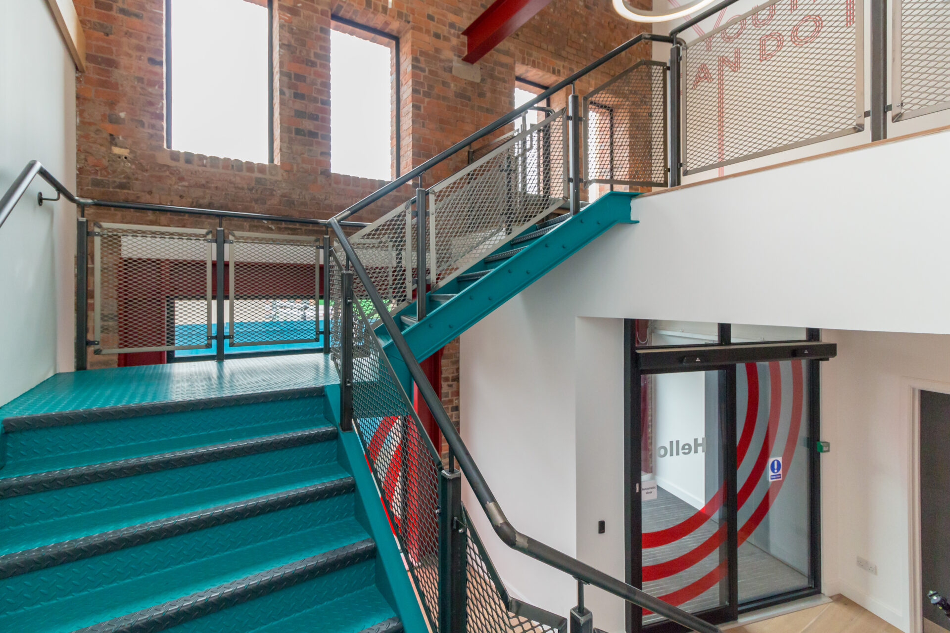 The interiors of the refurbished Prince’s Trust Birmingham, with newly installed bespoke steel staircases and glazed sliding doors.